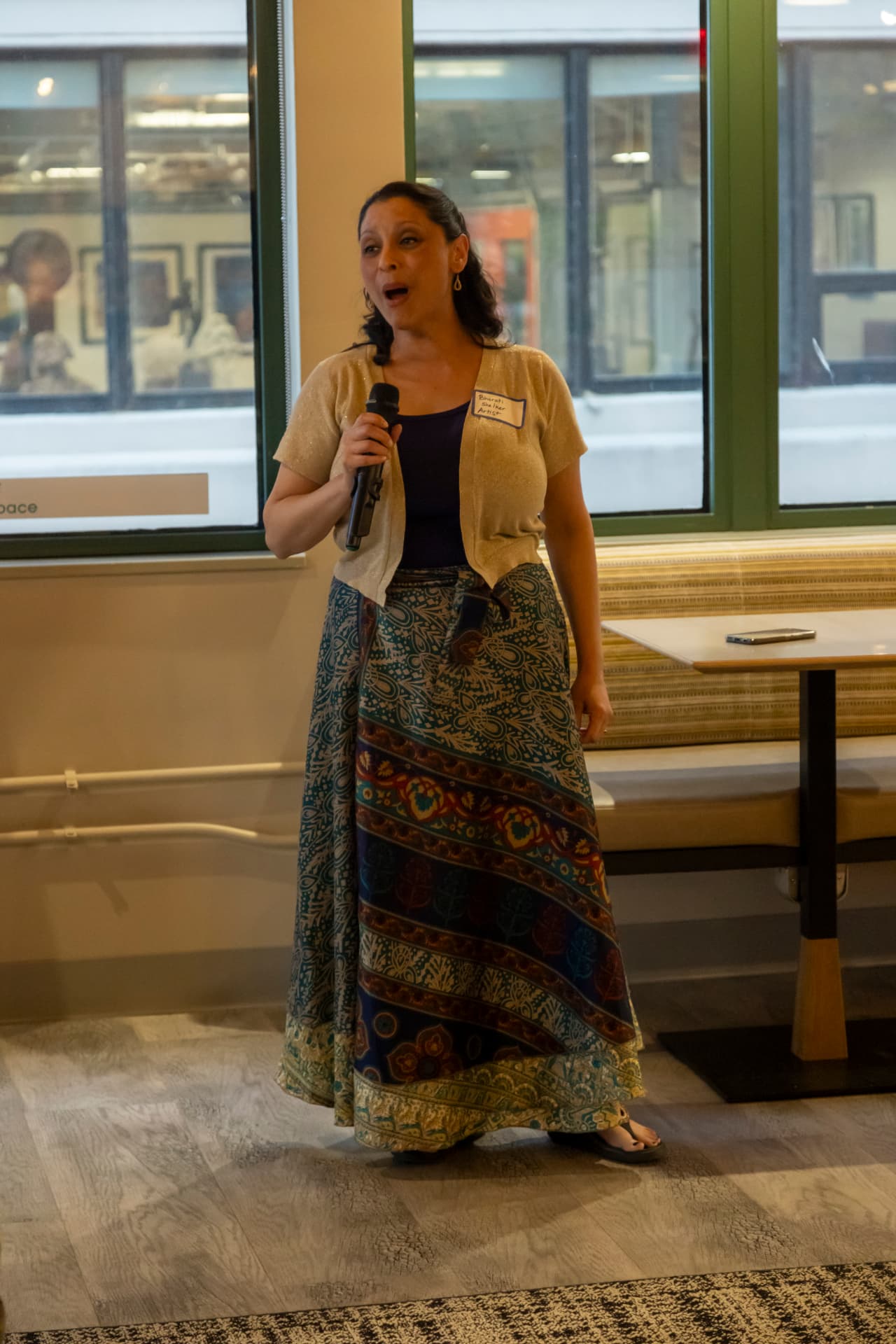 A vocalist performs into a microphone at a Heard community event.